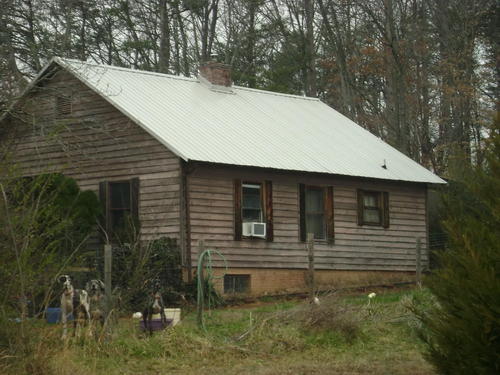 White metal roof on an old wood sided farmhouse, from a Metal Roof Installation job in Broadway